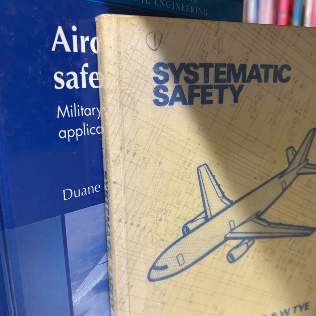 A picture of two books. The one at the front titled Systematic Safety by E. Lloyd and W. Tye. The second is obscured behind it, without the title on full show, it begins 'Aircraft'