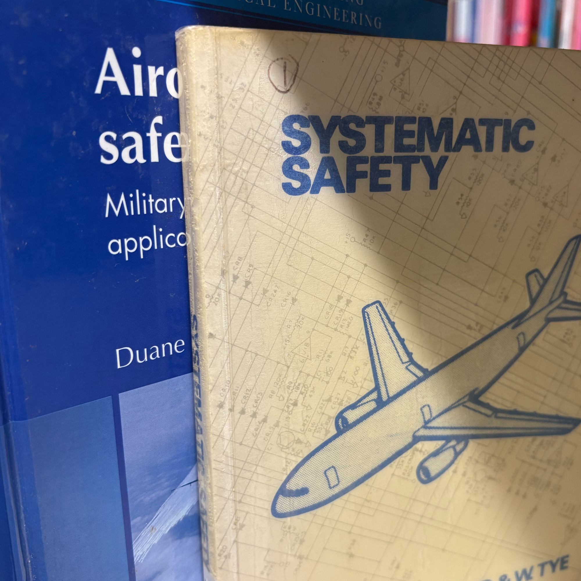 A picture of two books. The one at the front titled Systematic Safety by E. Lloyd and W. Tye. The second is obscured behind it, without the title on full show, it begins 'Aircraft'