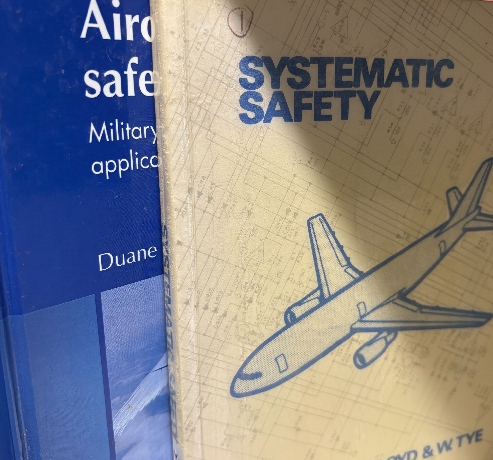 A picture of two books. The one at the front titled Systematic Safety by E. Lloyd and W. Tye. The second is obscured behind it, without the title on full show, it begins 'Aircraft'