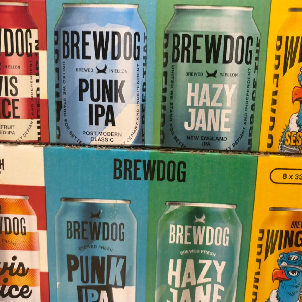 A picture of two packs of BrewDog beer cans stacked on top of each other. Four different types, from left to right, Elvis Juice, Punk IPA, Hazy Jane and Wingman