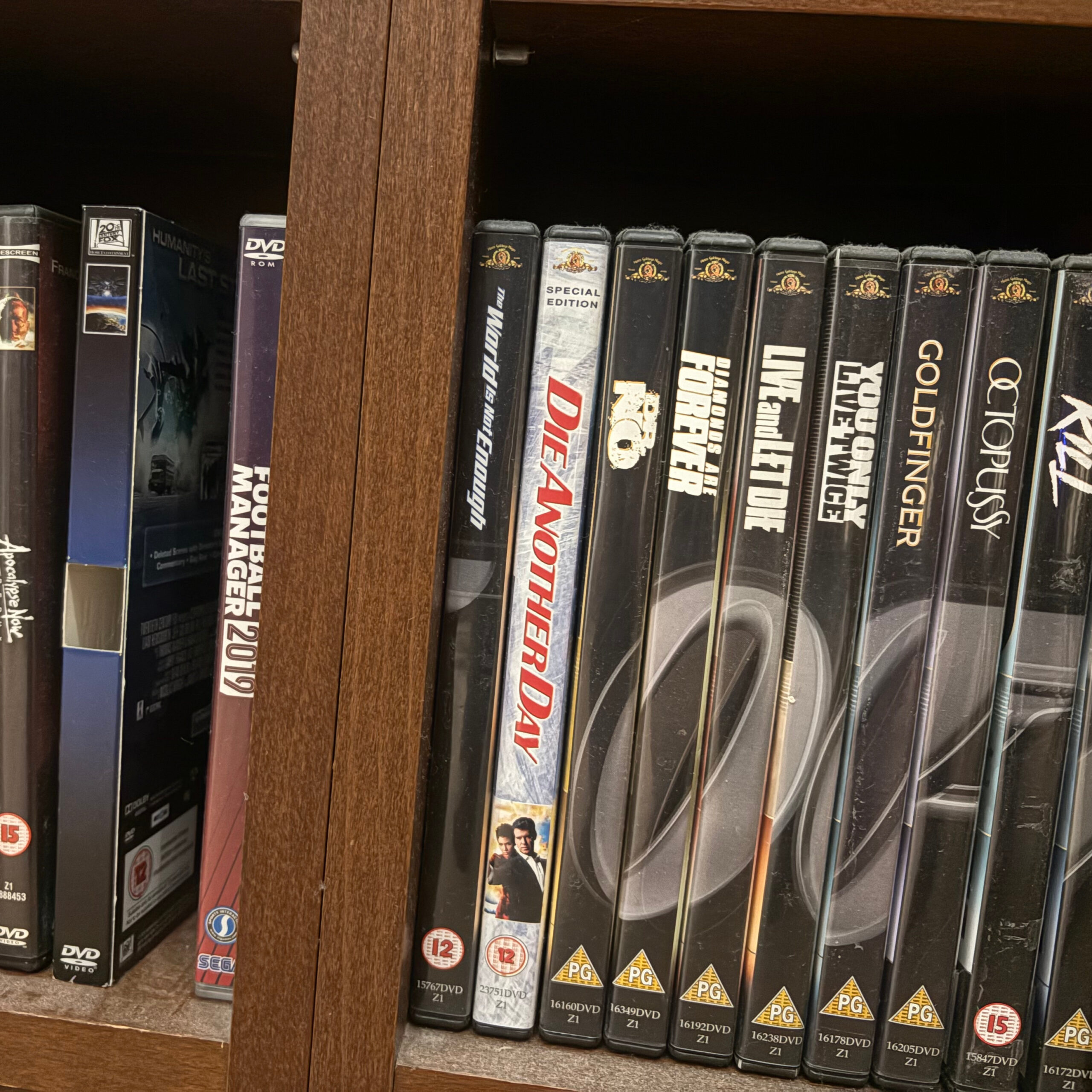 A photo of shelving containing a selection of DVDs